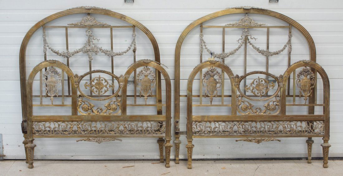 Pair of arched top single brass beds, cast garland: Pair of arched top single brass beds, cast garland decoration, headboard 46" h, with rails, probably French, early 20th C