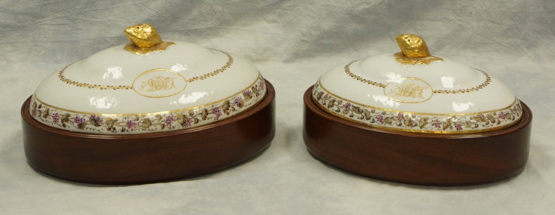 Pr 18th c oval Chinese Export porcelain casserole lids: Pr 18th c oval Chinese Export porcelain casserole lids on custom hardwood box form bases, gilt pomegranate handles, reserves with 3 letter gilt monogram, gilt and vine border with jeweled berry cluste