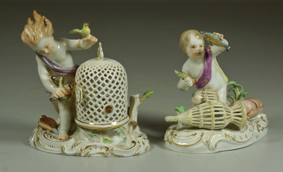 (2) Meissen porcelain figurines, cherub with fish in: (2) Meissen porcelain figurines, cherub with fish in trap, (tip of leaf missing), cherub with bird cage, 2 small pieces present for restoration, bird wing, bellows handle missing, tallest 5", crossed