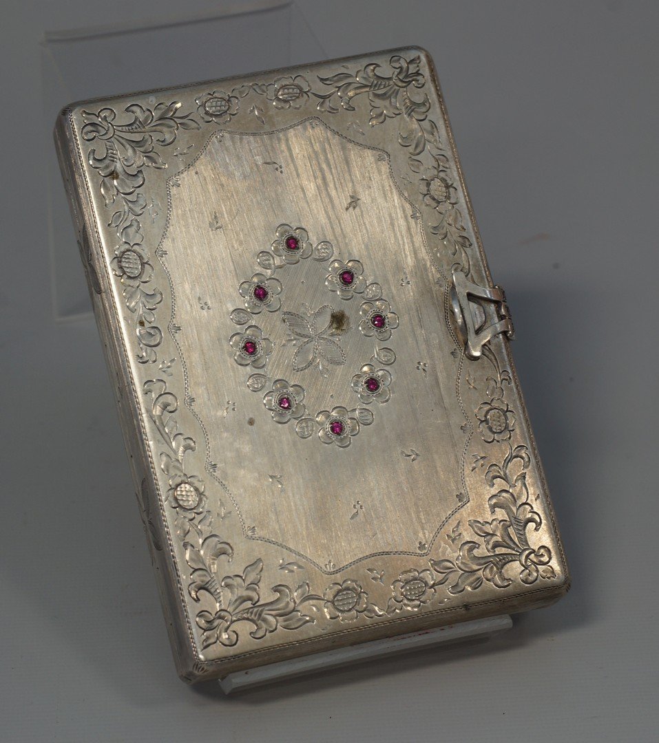 800 silver lady's vanity box, fitted for rouge,: 800 silver lady's vanity box, fitted for rouge, lipstick, and cigarettes, fitted with mirror, finely engraved and set with small red stones, gross weight 9.1 oz, 4 3/4" wide