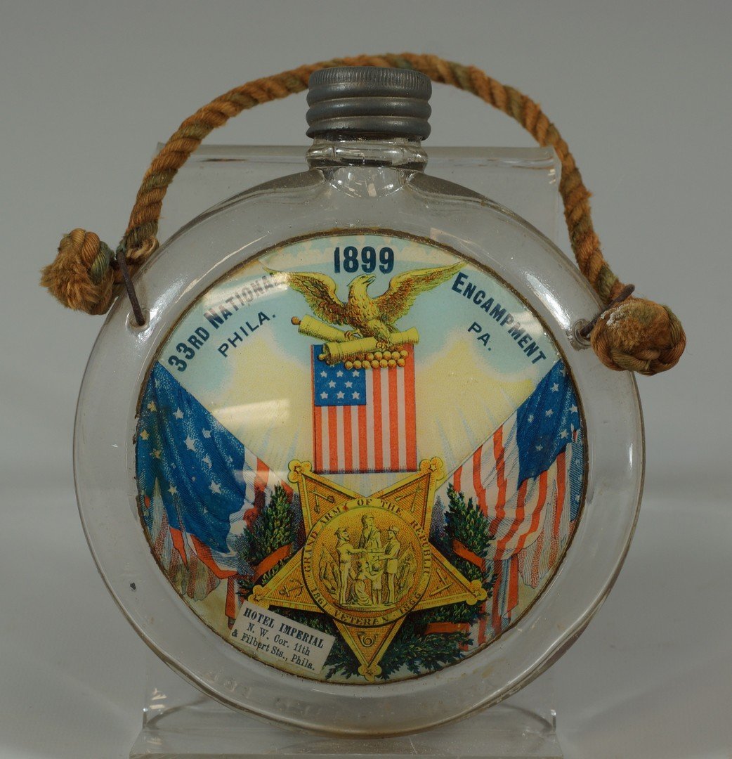 1899 Pressed Glass Souvenir GAR Reunion Canteen.: 1899 Pressed Glass Souvenir GAR Reunion Canteen. Lithographed and applied polychrome illustration on face shows: two draped flags with members badge in center and "33rd National Encampment, 1899, Phil