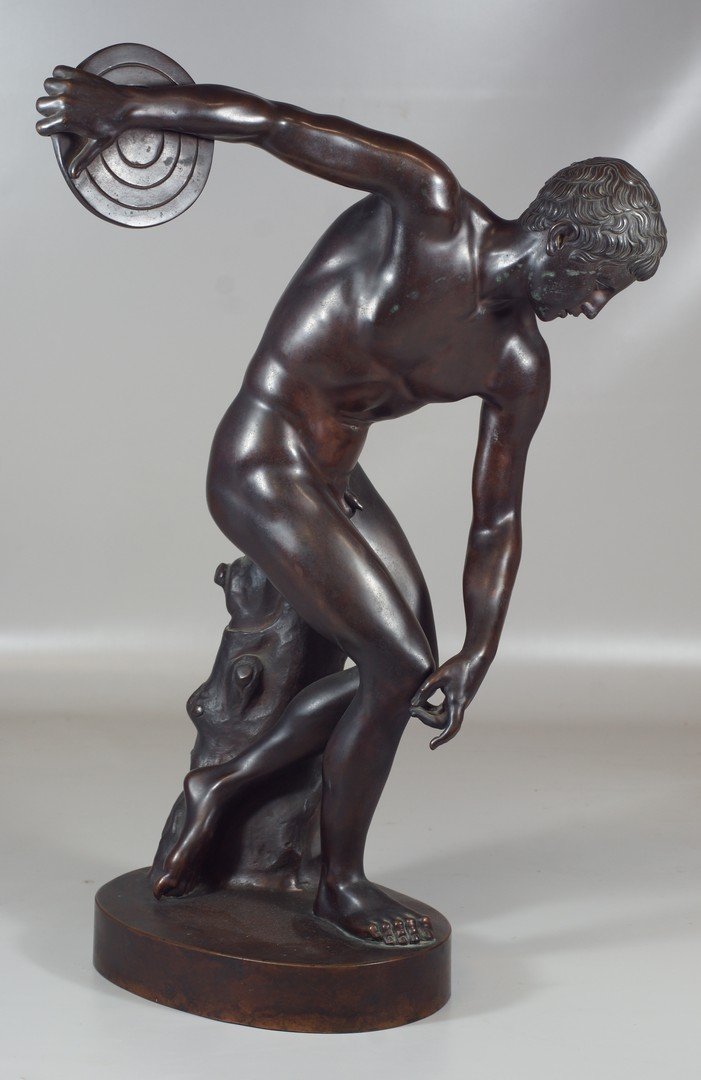 Bronze statue depicting a Roman discus thrower, marked: Bronze statue depicting a Roman discus thrower, marked at rear "A Del Nero & G Fasoli, Roma" on an oval plinth base, 23" high. Damage to patina on face.