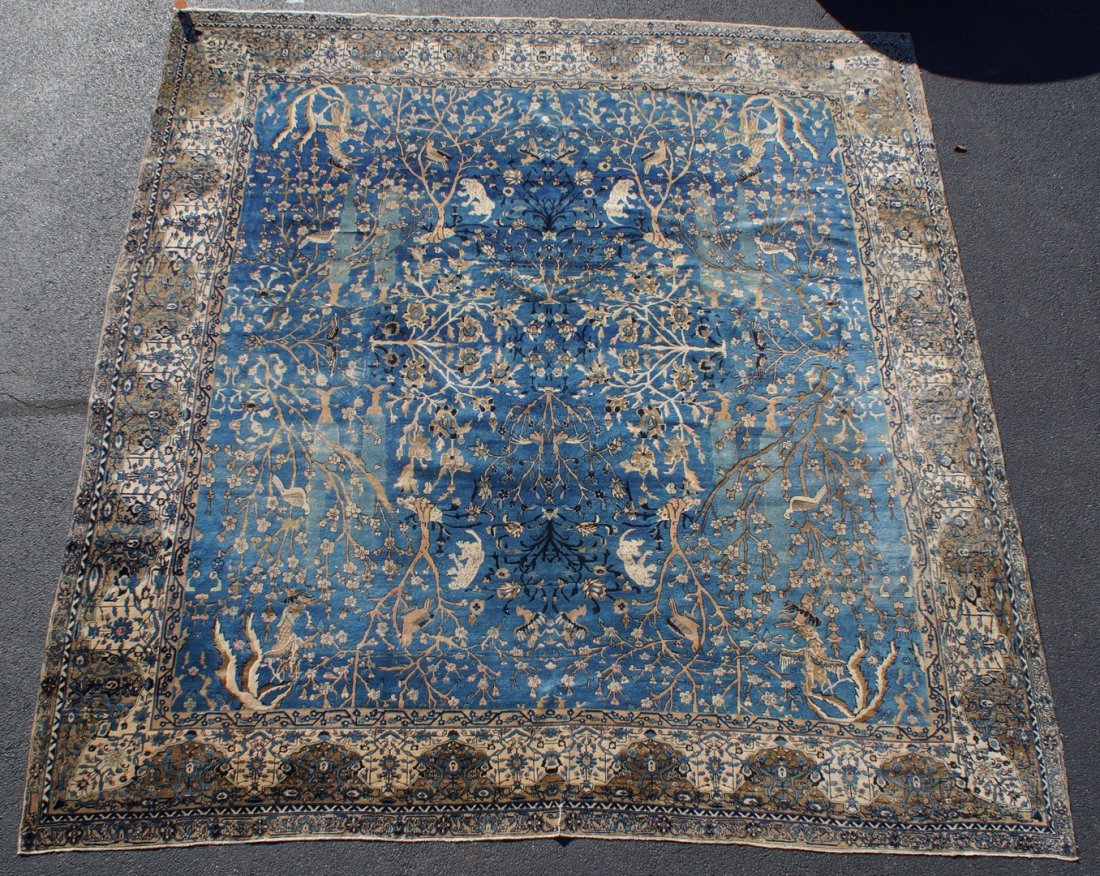 13'9" x 14'10" hunt pattern Indian Larastan: 13'9" x 14'10" hunt pattern Indian Larastan, medium blue field, exotic animals and birds throughout floral field, some wear evident throughout, outer minor guard border missing throughout