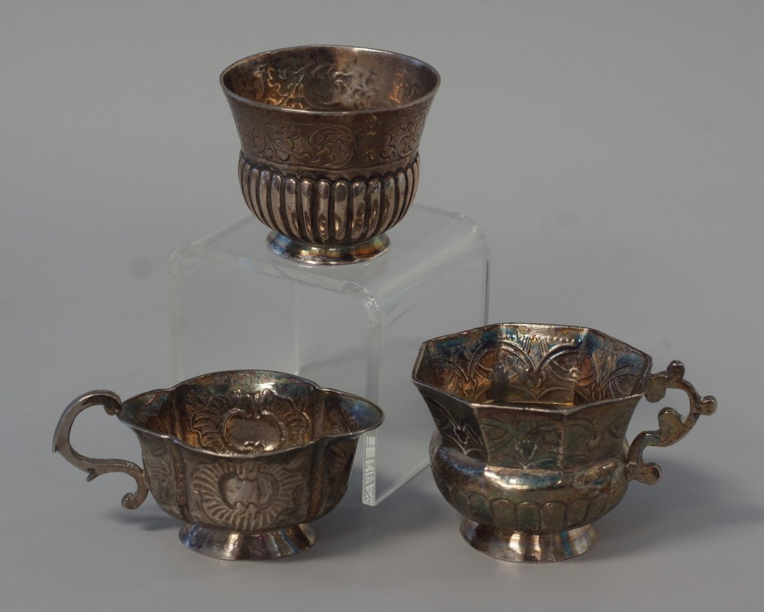(3) early Russian silver items, (2) teacups, small wine: (3) early Russian silver items, (2) teacups, small wine cup, with late 18th/early 19th c St George slaying the dragon marks, with various makers' assayers marks, one dated 1778, 2.66 TO, typically 1 3
