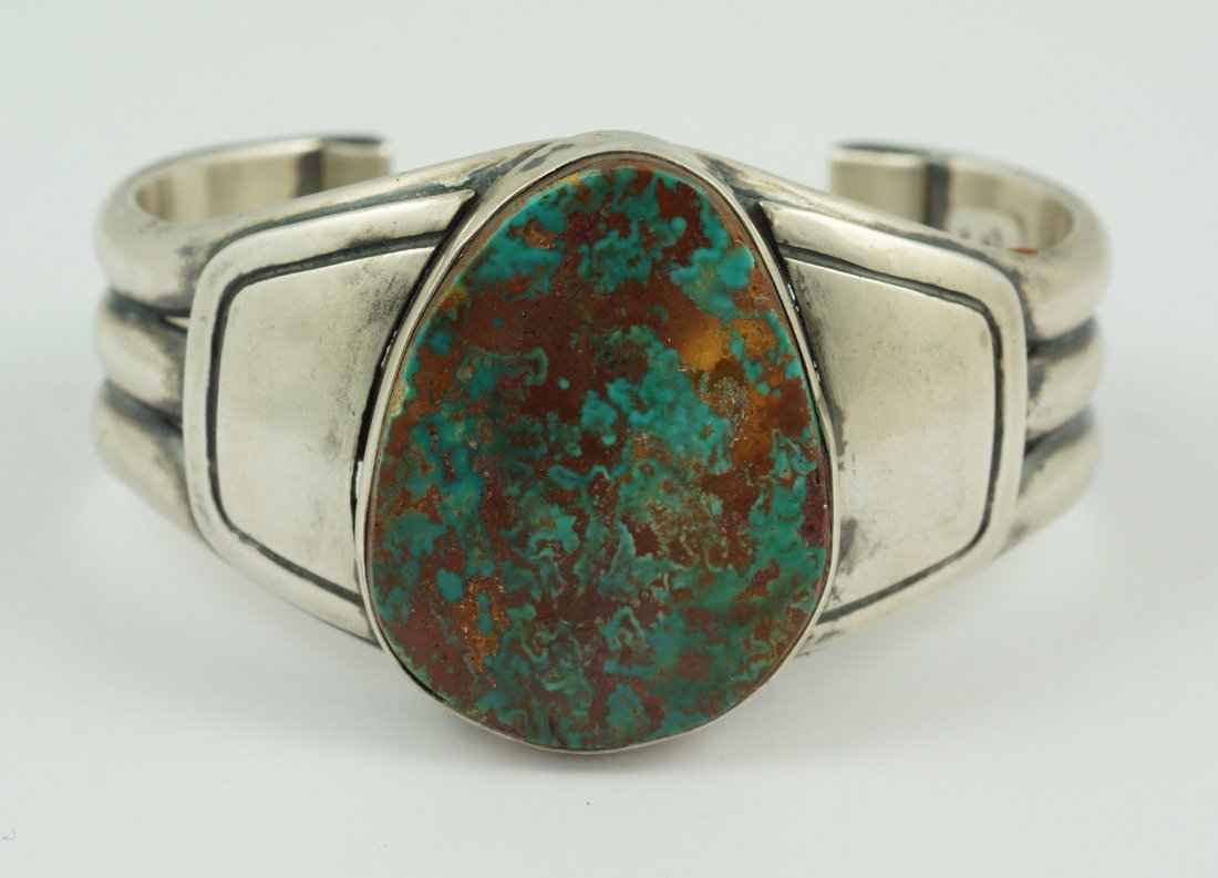 J Piaso, Jr sterling silver & turquoise traditional: J Piaso, Jr sterling silver & turquoise traditional Navajo bracelet, large bezel turquoise oval stone, could be Pilot Mountain turquoise, marked "J Piaso, Jr" inside of feather, "sterling", "c", 2 5/8