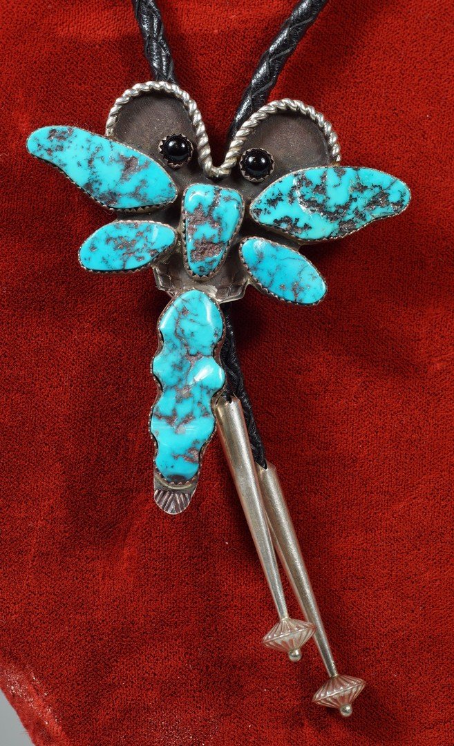 Brad Panteah Navajo traditional style bolo tie,: Brad Panteah Navajo traditional style bolo tie, dragonfly with 6 bezel turquoise stones, 2 jet stone eyes, twisted wire antenna, stamp-work on tail, black leather with commercial silver tips, marked "