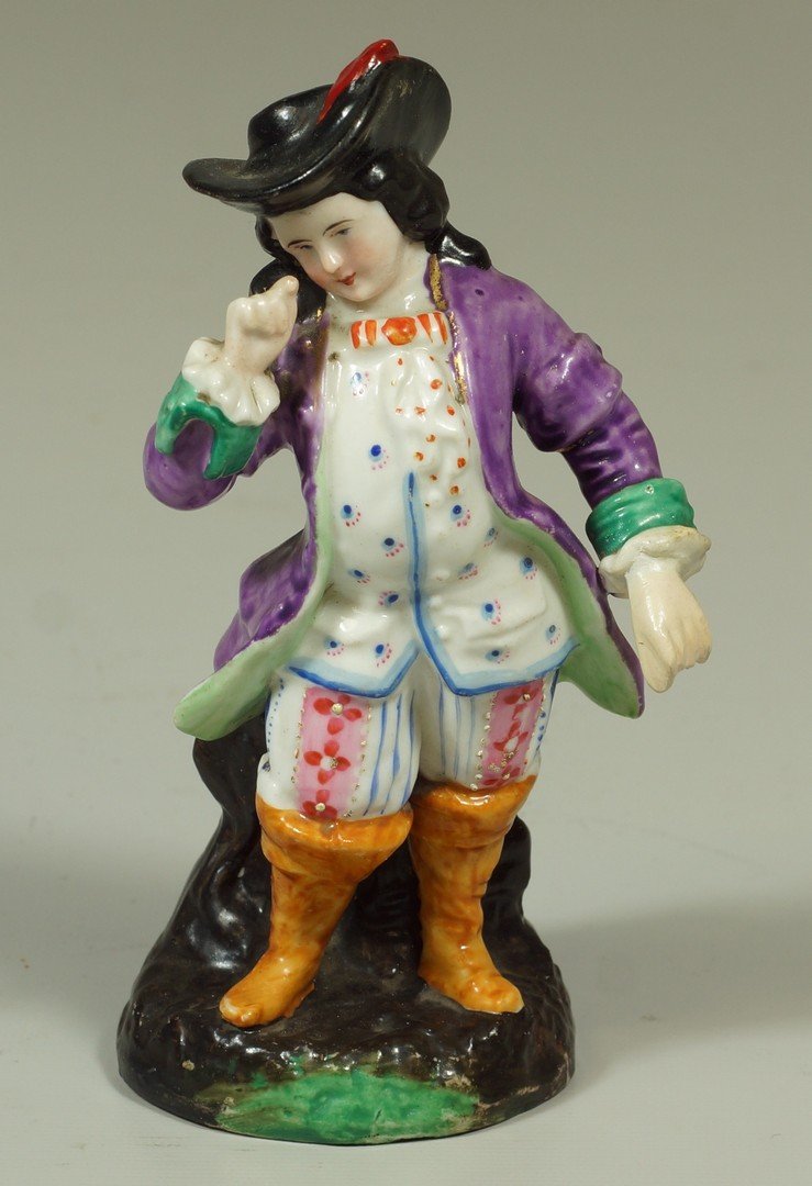 19th c Continental porcelain figure of a gentleman, hat: 19th c Continental porcelain figure of a gentleman, hat with feather, purple coat, floral pants and high boots, marked 1402 I 64, 5-1/4" high, left hand restored