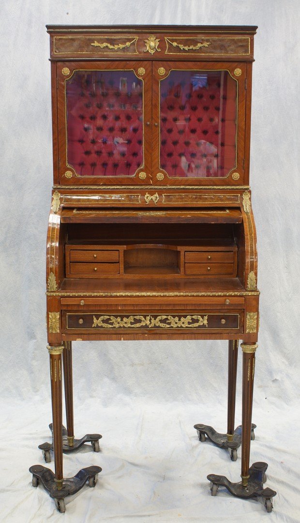 Louis XVI style roll top desk, late 20th c, gilt metal: Louis XVI style roll top desk, late 20th c, gilt metal mounts overall, 2 glass doors above roll top opening to small drawers and pull out writing surface below long drawer, on circular fluted tapering