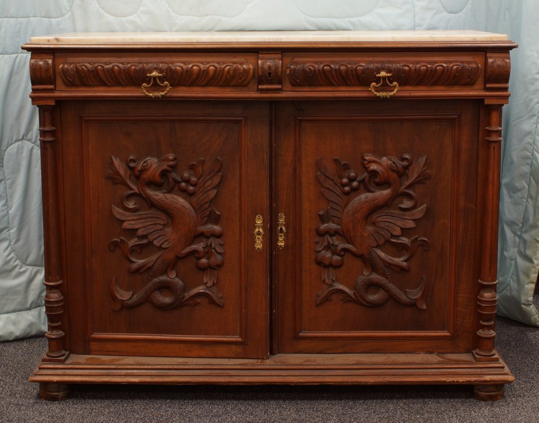 Carved walnut Victorian marble top server, doors carved: Carved walnut Victorian marble top server, doors carved with winged gryphons, 49" w, 38" h