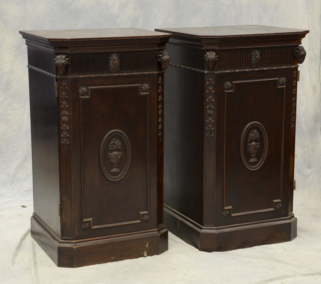 Pr carved mahogany Italian style side cabinets, each: Pr carved mahogany Italian style side cabinets, each with a single door with carved rams heads at top corners, urns at center, bellflowers at corners, c 1900, 23 5/8" w, 41 1/2" h, 21 3/4" d
