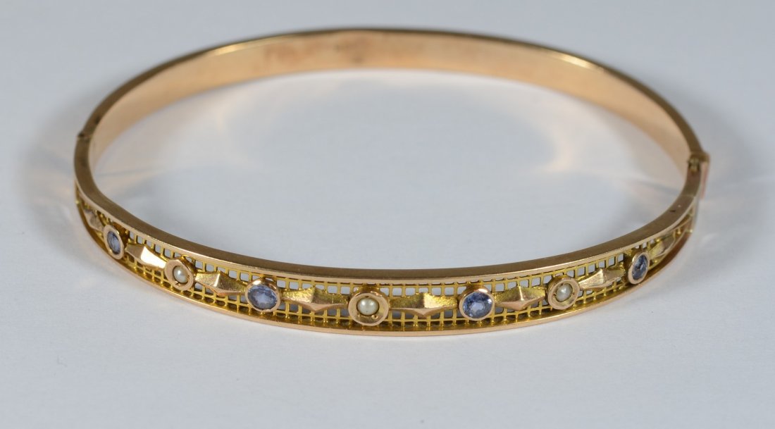 10K YG filigree hinged bangle bracelet, set w/pearls: 10K YG filigree hinged bangle bracelet, set w/pearls and small blue stones, 2 3/16" x 1 7/8" inside, 4.2 dwt