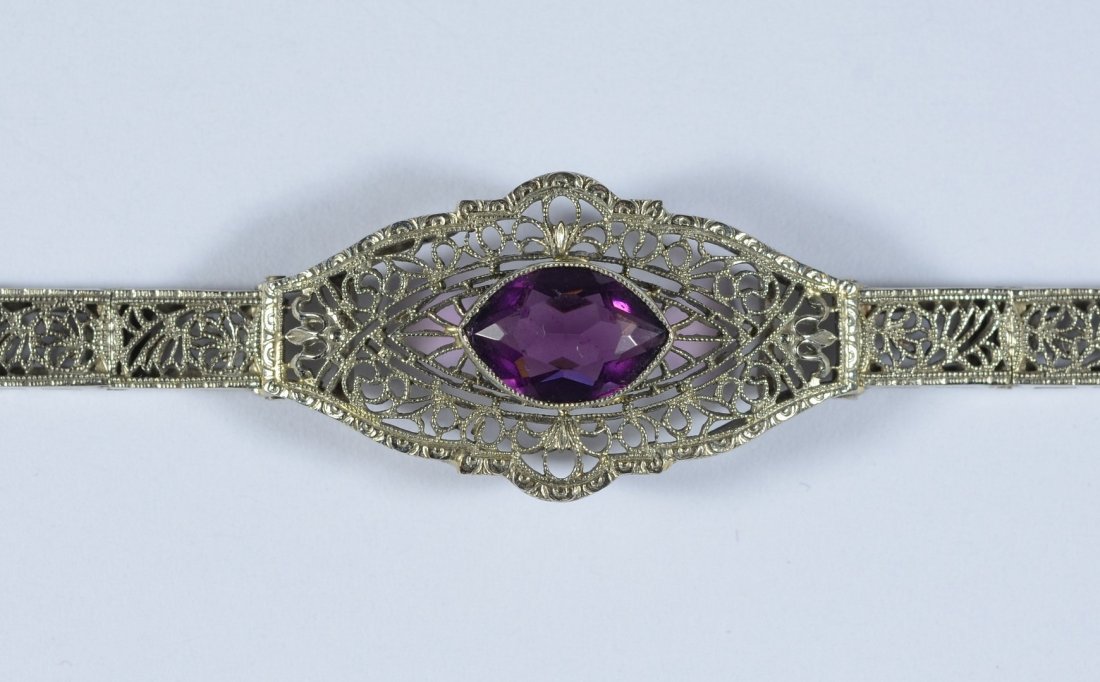 10K WG filigree bracelet, amethyst colored stone in: 10K WG filigree bracelet, amethyst colored stone in center, 6 3/8" l, 4.5 dwt