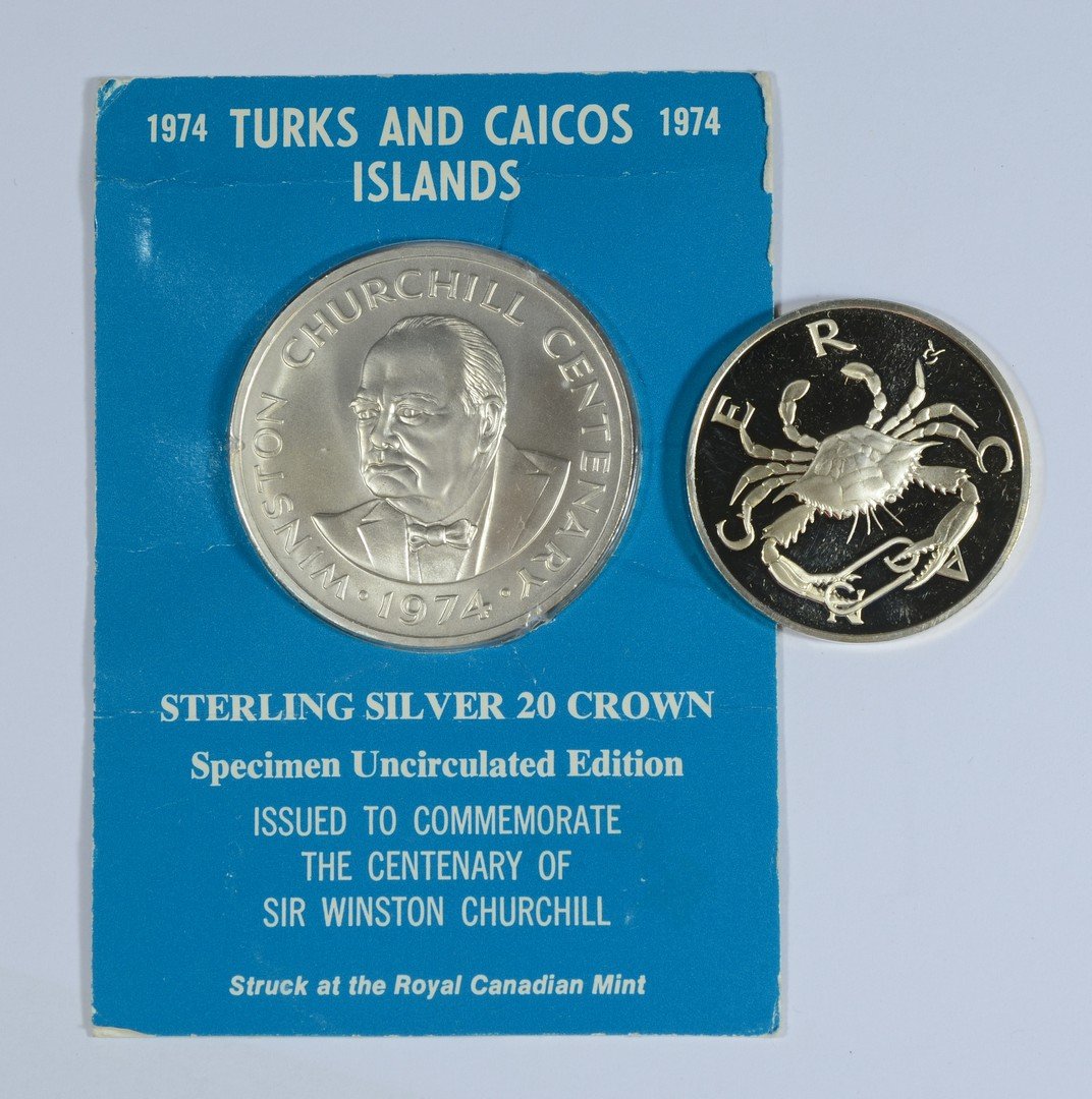 2 sterling commemorative coins: Franklin Mint sterling silver Cancer Zodiac coin, .79 TO, w/a 1974 Turks Caicos 20 Crown sterling silver Sir Winston Churchill Comm coin from the Royal Canadian Mint, 1.24 TO, 2.03 TO total weight