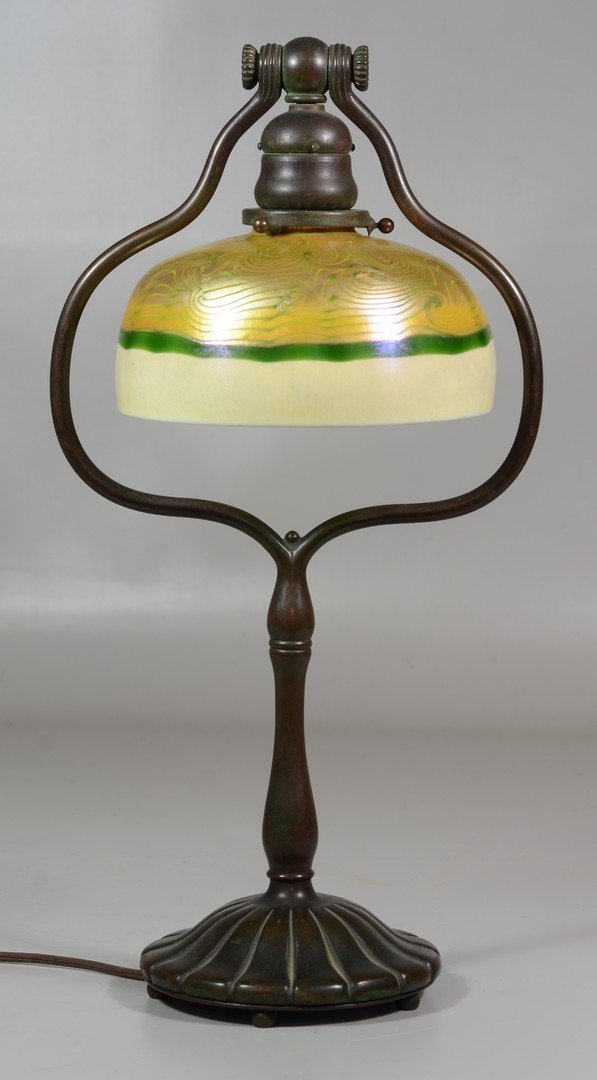 Tiffany Studios Harp Desk Lamp, marked "Tiffany Studios: Tiffany Studios Harp Desk Lamp, marked "Tiffany Studios New York 424" to base, gold & green Favrile shade signed "L.C.T.", rim of shade with 1" wide x 1/4" h surface chip, also a 1/2" w x 1/4" h chip 