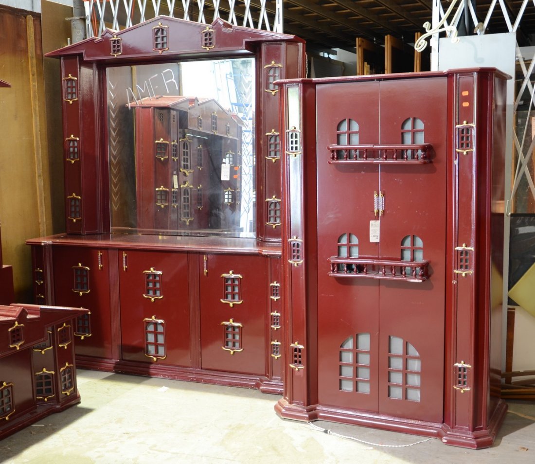 Huge unusual 2-piece bedroom set, brick red with gilt: Huge unusual 2-piece bedroom set, brick red with gilt highlights, covered in little windows, triple dresser with mirror, mirror etched "AMER", 90" h x 73-1/2" w x 23-1/2" d, with a 2-door armoire with