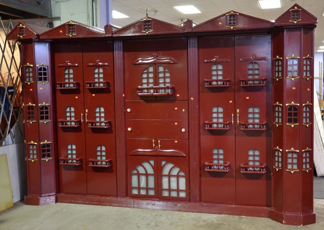 Monumental unusual wall unit, brick red with gilt: Monumental unusual wall unit, brick red with gilt highlights, covered in little windows, consisting of 2 double door armoires, shelving & drawers, 92" h x 146" w x 33" d, originally lit, needs rewirin