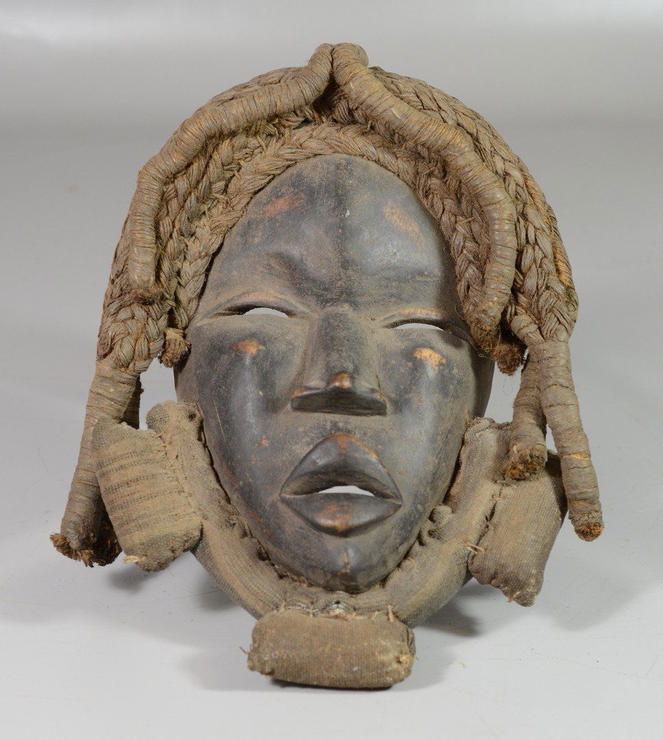 Wood mask of oval form with large slit eyes, shaped (1 of 2)