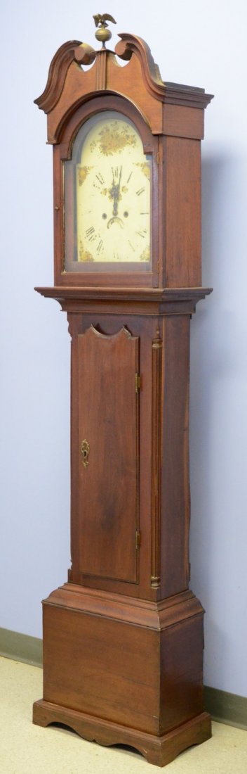 Mahogany tall case clock, scroll top bonnet containing: Mahogany tall case clock, scroll top bonnet containing a 30 hour movement faced with an 8 day dial, single weight and pendulum, unsigned, c 1800, 85" tall