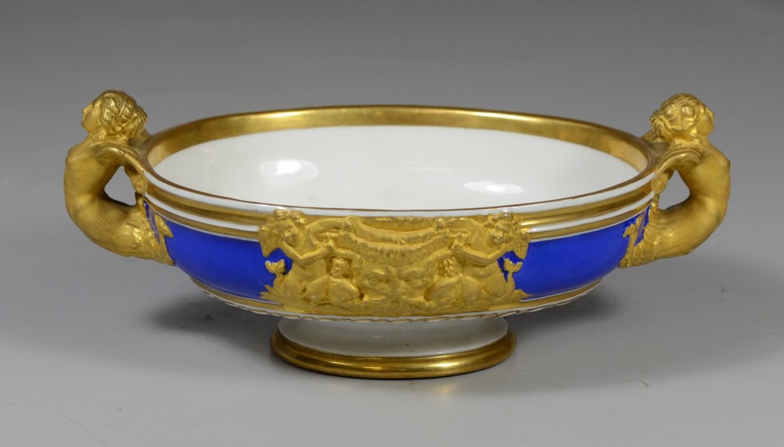 KPM cobalt blue and gilt bowl, caryatid handles,: KPM cobalt blue and gilt bowl, caryatid handles, Classical frieze with a mask and cherub medallion to front, face medallion to reverse, 3-3/4" high, 9" wide