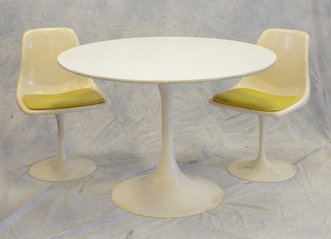 After Eero Saarinen, metal base and laminate top tulip: After Eero Saarinen, metal base and laminate top tulip table, 42" diam, with 2 swivel bucket chairs, all unsigned
