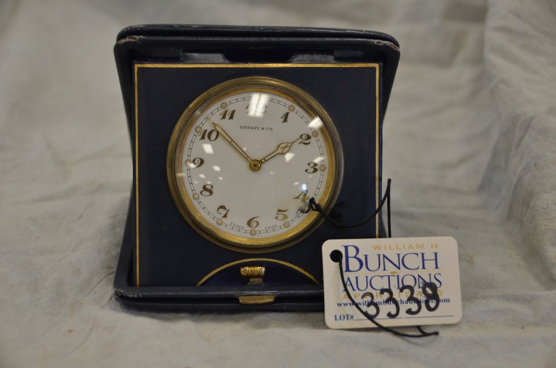 Tiffany & Co folding travel clock, blue leather case,: Tiffany & Co folding travel clock, blue leather case, movement by Cortland Concord Watch Co, 15 joules unadjusted, runs when wound, dial 2-1/4" dia, case 4-1/4" square