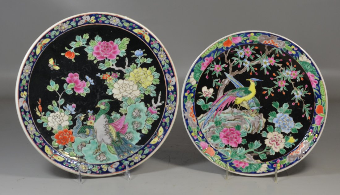 2 Japanese famille noir chargers, both with exotic: 2 Japanese famille noir chargers, both with exotic birds, one marked Nippon to base, largest 12" dia