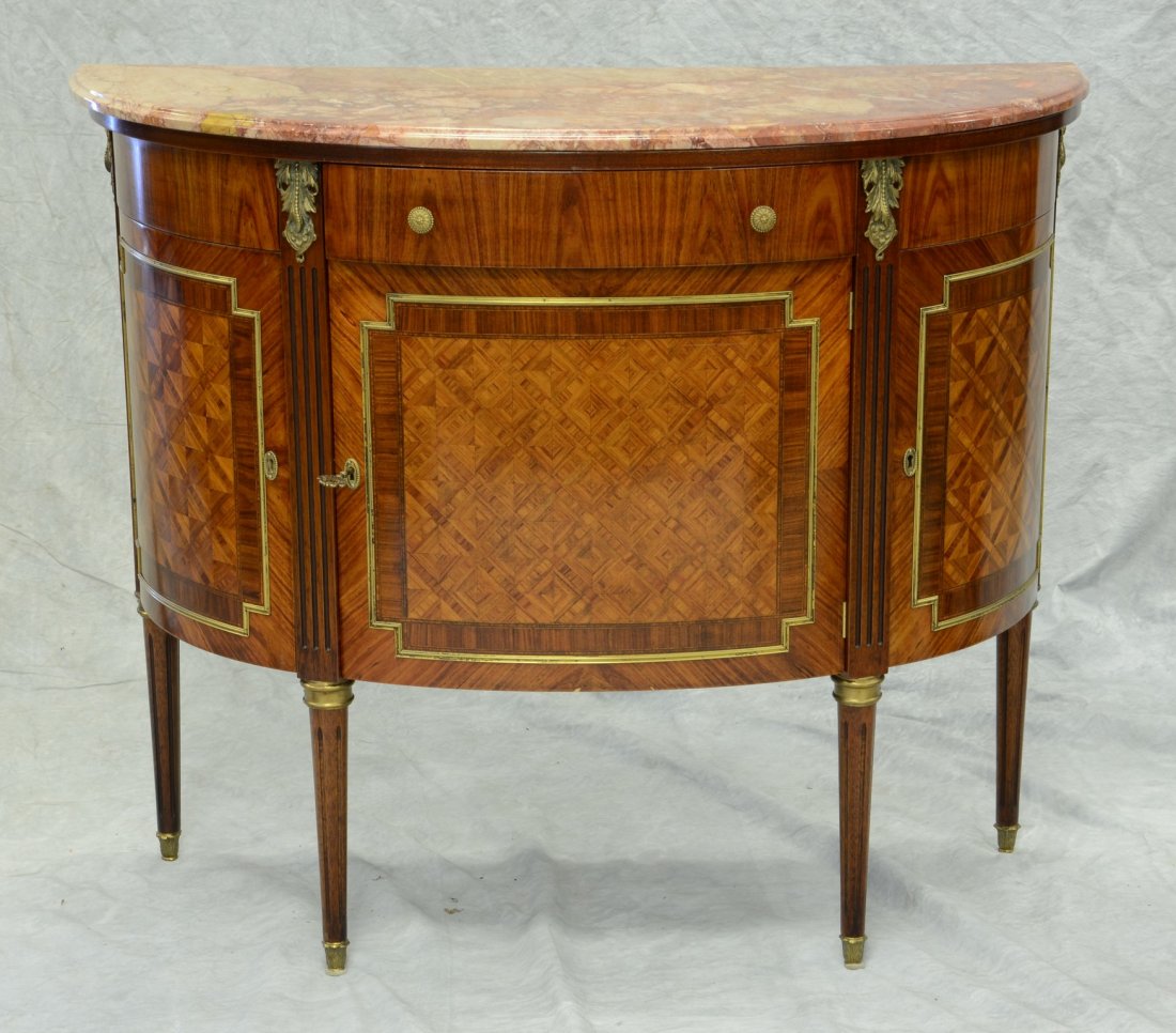 Baggio inlaid and gilt metal mounted Louis XVI style: Baggio inlaid and gilt metal mounted Louis XVI style Demilune commode with brown marble top, 37-1/2" h, 45" w, 18-1/2" d, Center door locks and not able to open