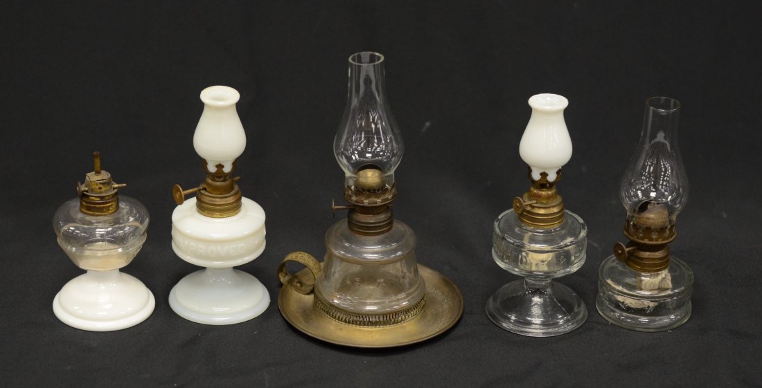 (5) Miniature clear & milk glass oil lamps, "Little: (5) Miniature clear & milk glass oil lamps, "Little Banner" with chimney, "Little Jim" lacking chimney, "Little Duchess" on brass base with finger handle with chimney, "Improved Banner" with milk glas