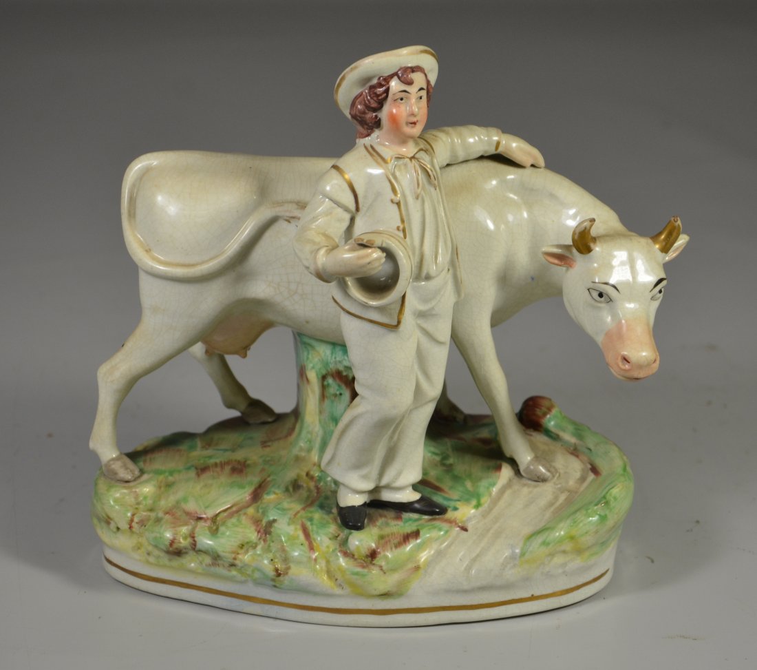 Staffordshire pottery figurine, young man with cow,: Staffordshire pottery figurine, young man with cow, 8-1/4" h