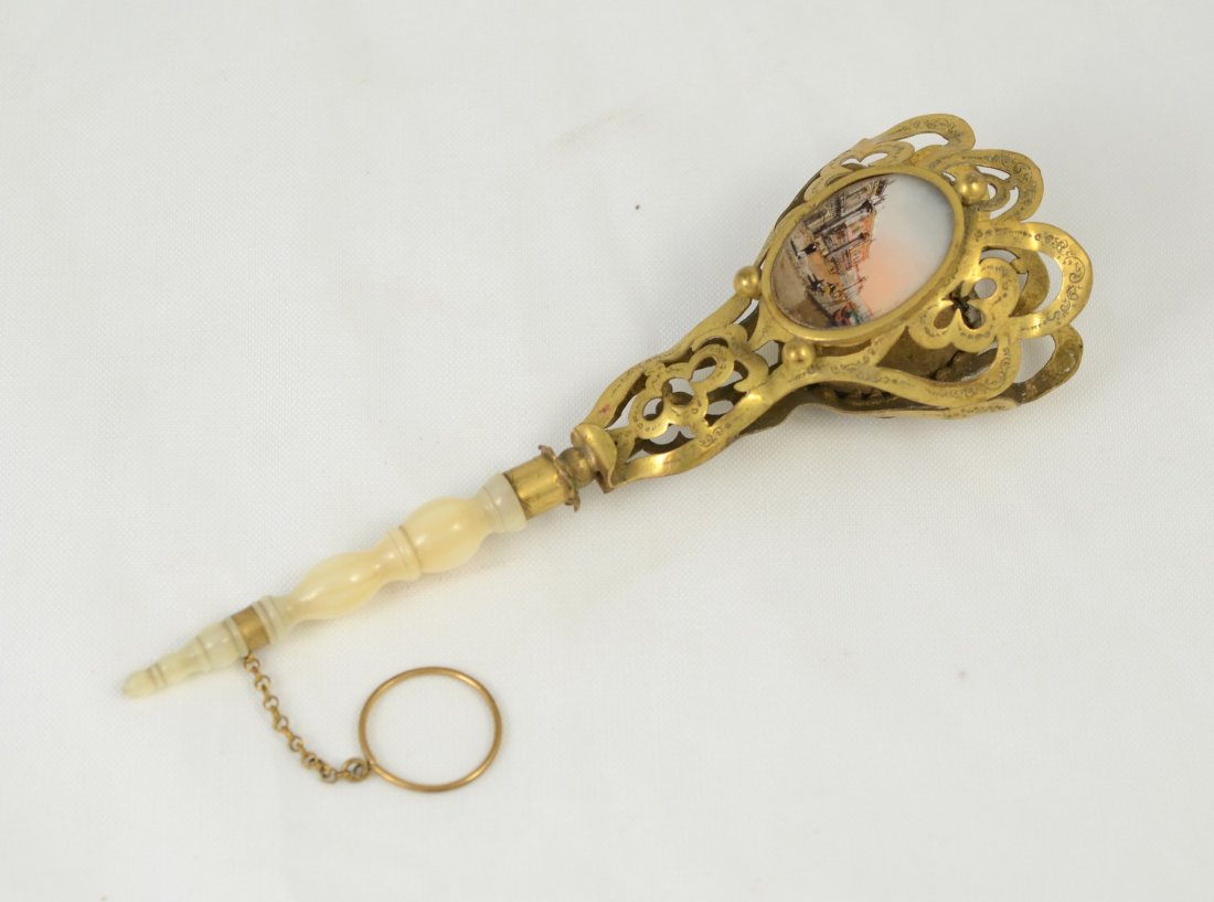 Grand Tour tussie mussie, engraved brass, Mother of: Grand Tour tussie mussie, engraved brass, Mother of Pearl handle, eglomise scenic panel and a flirting mirror on opposite side, finger ring, 6 5/8" l; condition: Loss to silvering on mirror consistent