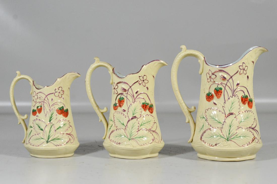 3 Graduated English strawberry decorated pitchers, (1 of 2)