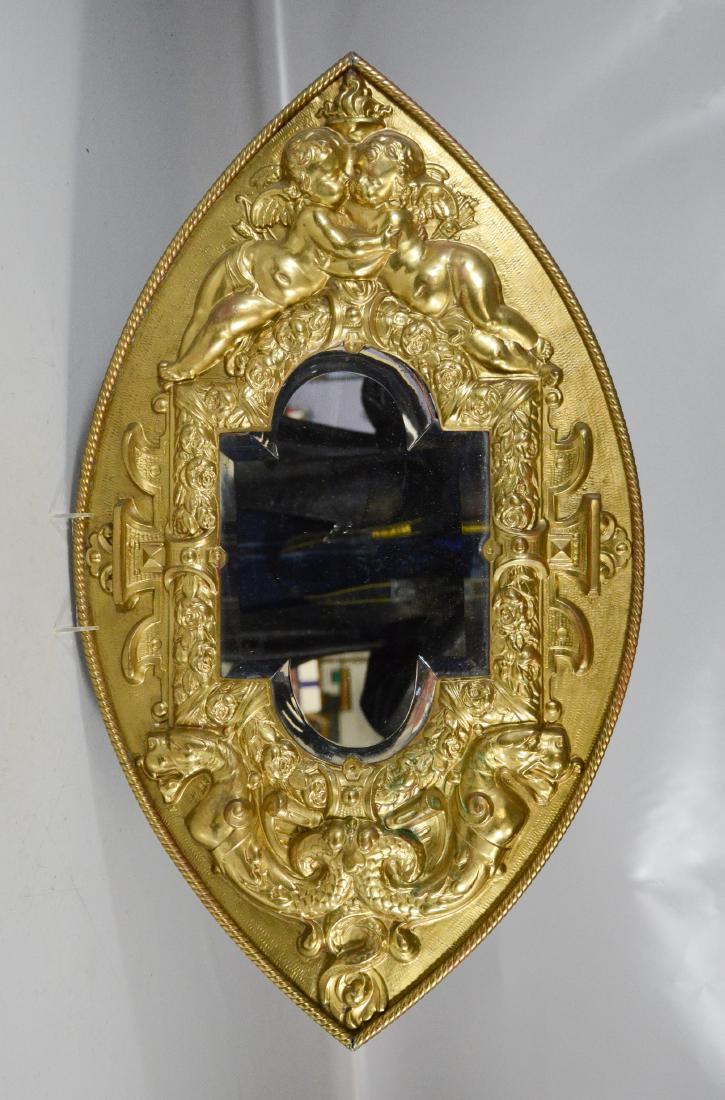 Elliptical embossed brass wall mirror, embracing (1 of 2)