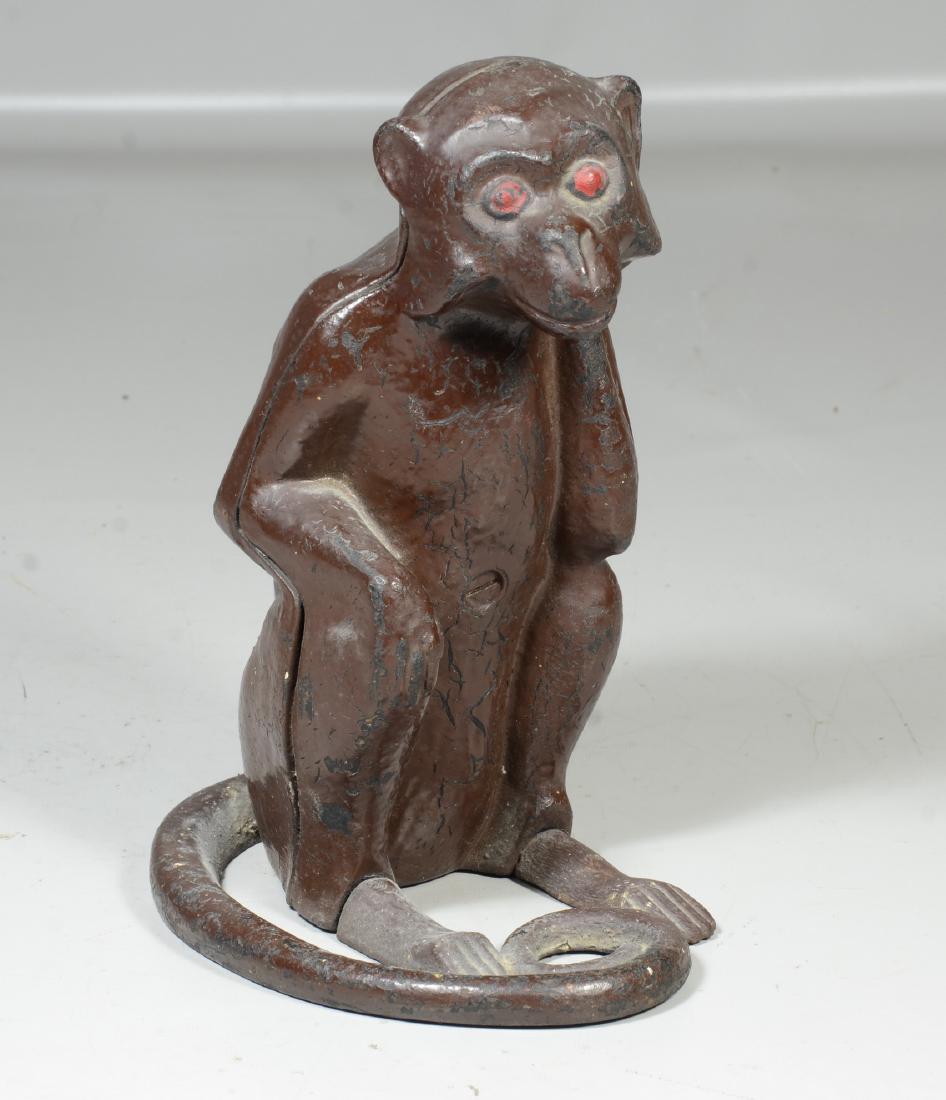 Cast iron monkey doorstop, figure of a seated monkey, (1 of 5)