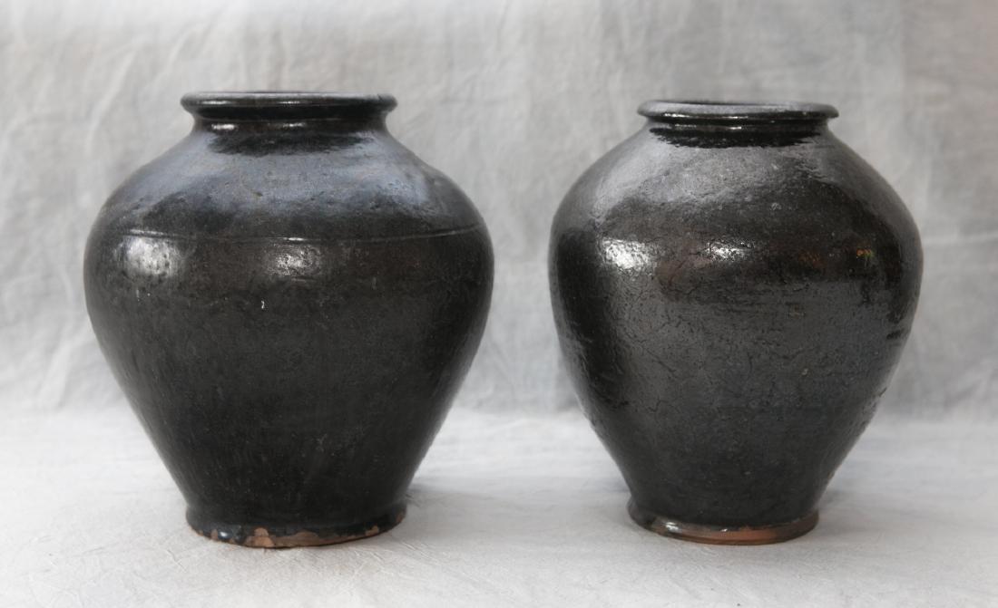 (2) Black glazed redware ovoid jars, each with some (1 of 4)