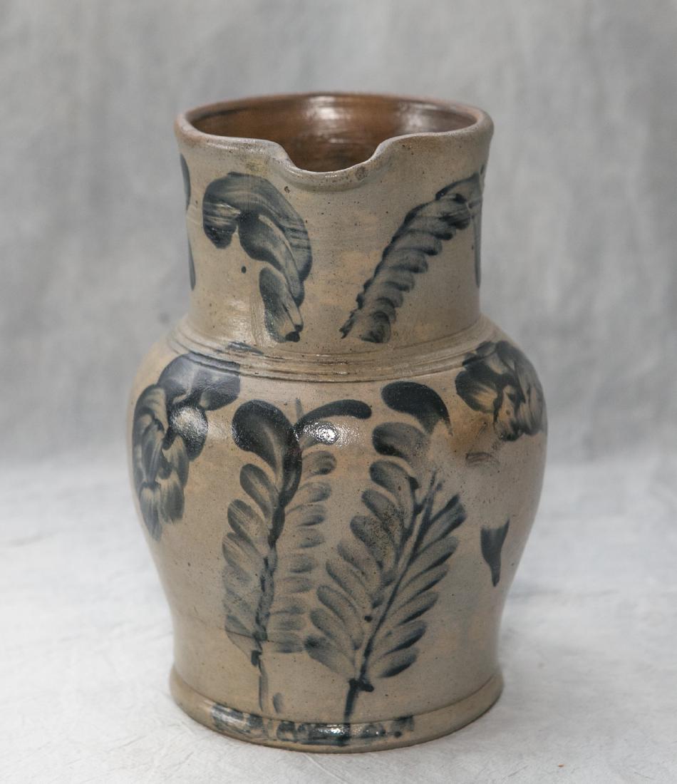 Blue decorated stoneware pitcher in the manner of (1 of 3)