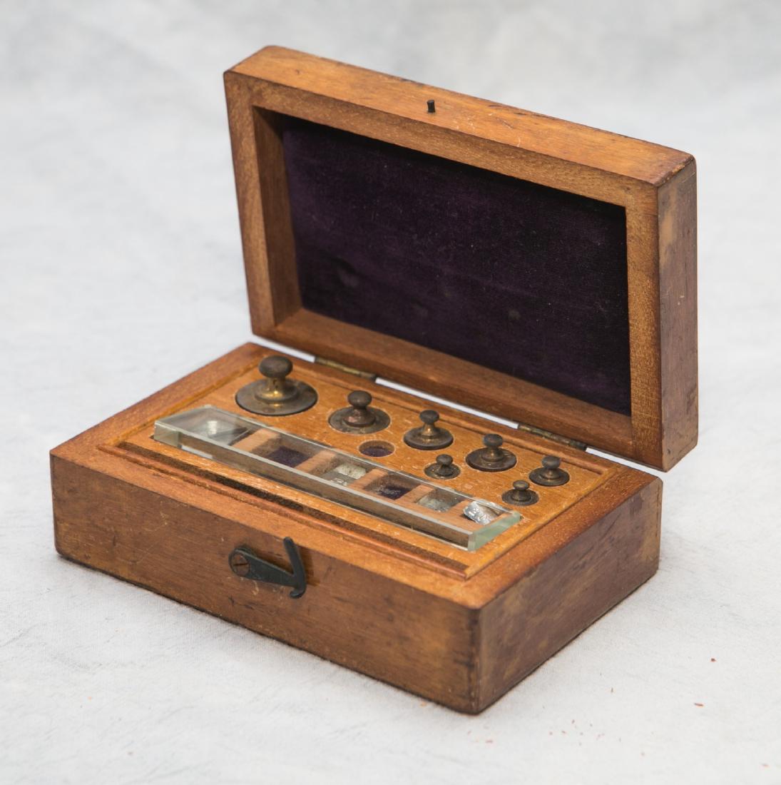 Wooden case with brass and lead leaf scale weights,: Wooden case with brass and lead leaf scale weights, missing 3 weights,4-7/8" w x 3-1/8" d