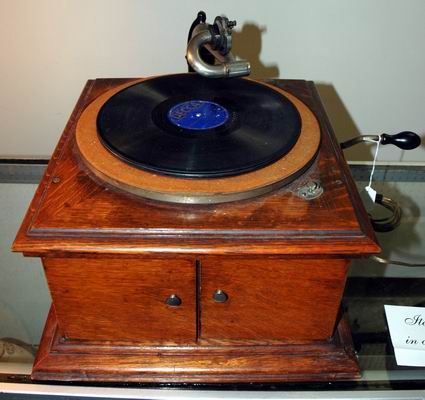 ANTIQUE OAK VICTOR TALKING MACHINE: Needle arm is marked Victor Talking Machine Exhibition Camden, N.J. Nice oak case with 4 compartments behind the 2 drawers for record storage. We have had it running in the gallery. Approx. shipping a
