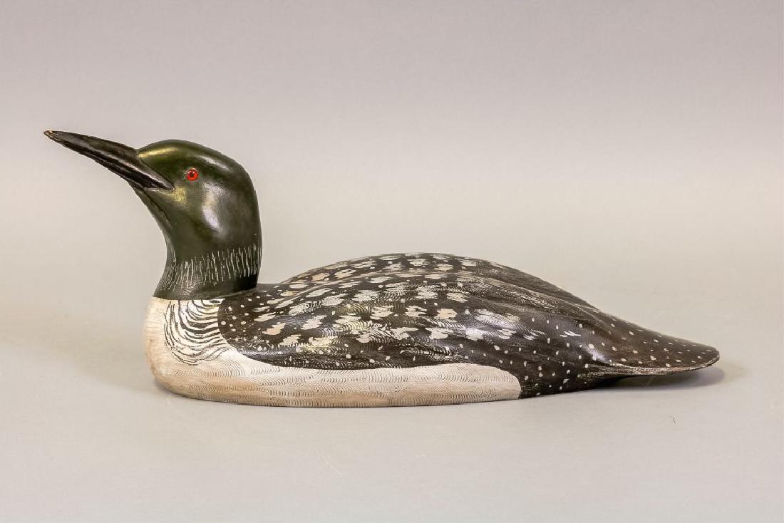 Charlie "Chas" Moore Common Loon Decoy, DeKalb,: IL, Glass Eyes, Solid Body, Original Paint w/Detailed combing on Back, a few small puppy teeth marks to tip of bill, Signed & dated 99 on Bottom, 21"L, Est. 150-200