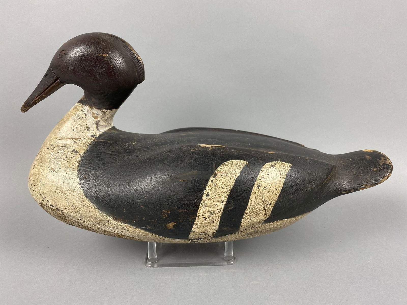 East Coast Merganser Hen Duck Decoy, branded D.C.B on: East Coast Merganser Hen Duck Decoy, branded D.C.B on bottom, stamped eyes, solid body, inleatted neck, original paint, some wear, puppy chew to tip of bill & some small wear areas on back & tail, gre