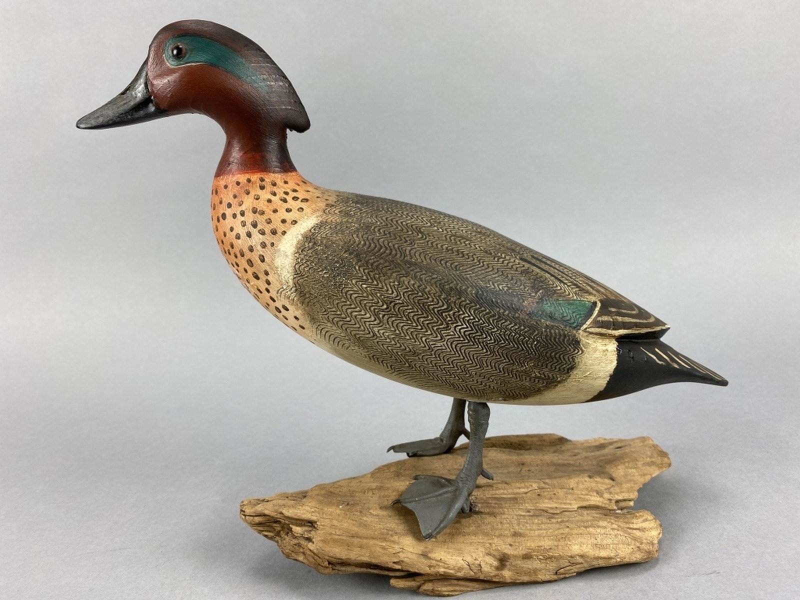 Ken Kirby Green-Winged Teal Drake: Little Egg Harbor, NJ, glass eyes, solid body, excellent form in standing position, metal legs, mounted on driftwood base, strong original paint with detailed combing, 13"L x 10"T, est. 200 - 400
