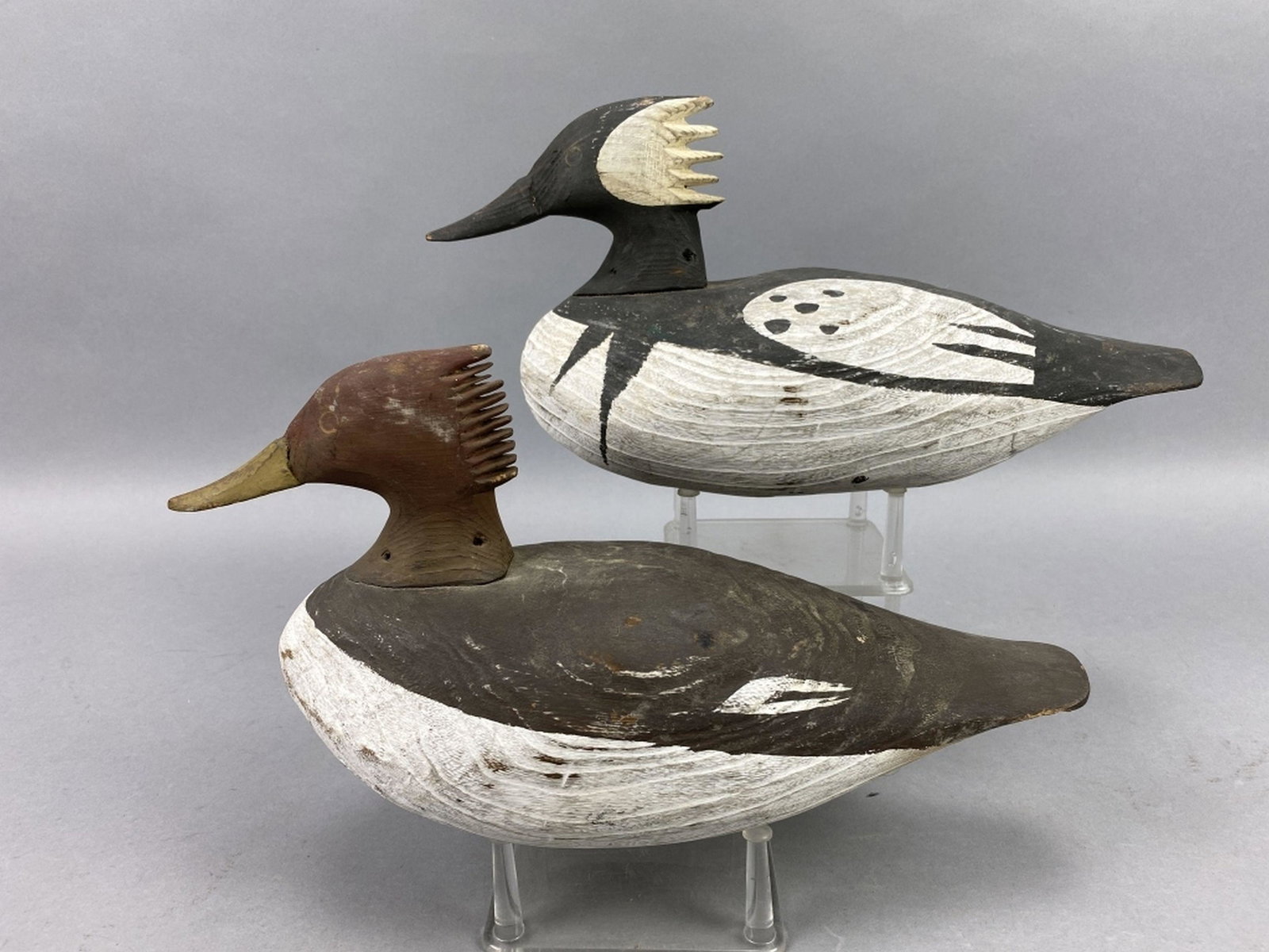 Pr of Hooded Merganser Duck Decoys: by unknown carver in the style of Doug Jester, painted eyes, solid bodies, original paint with light wear & a few rubs, excellent form, John Treutelaar Collection, 13.5"L, est. Market Determined