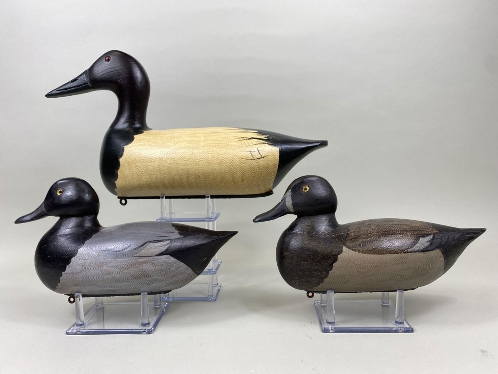 3 Duck Decoys: pr of Charles Moore bluebills, Dekalb, IL, glass eyes, hollow bodies, good original paint, nice combing detail, Perdew style weights on bottom & 1 Jim Slack canvasback drake, Pekin, IL, carved in the