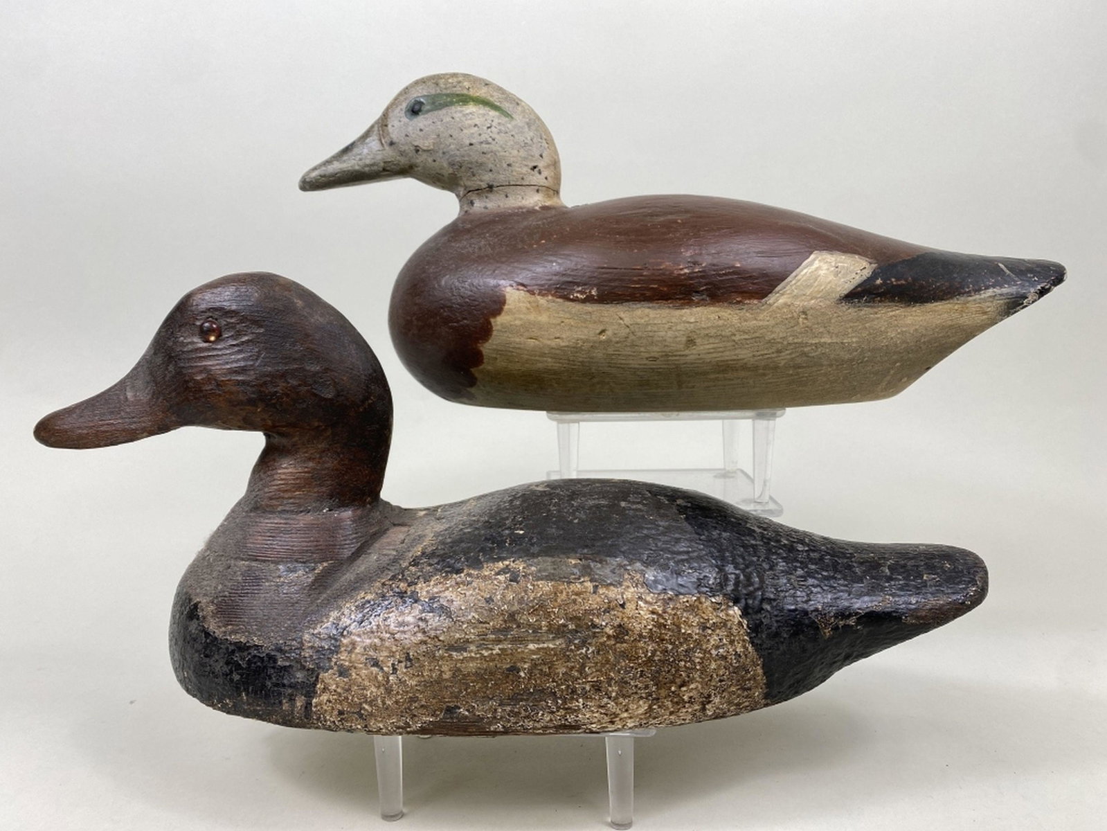 2 Duck Decoys: 1 bluebill drake by unknown carver, glass eyes, solid body, repainted, gunning wear, significant paint loss in head & neck area, multiple layers of paint & 1 Dodge widgeon drake, Detroit, MI, tack eye