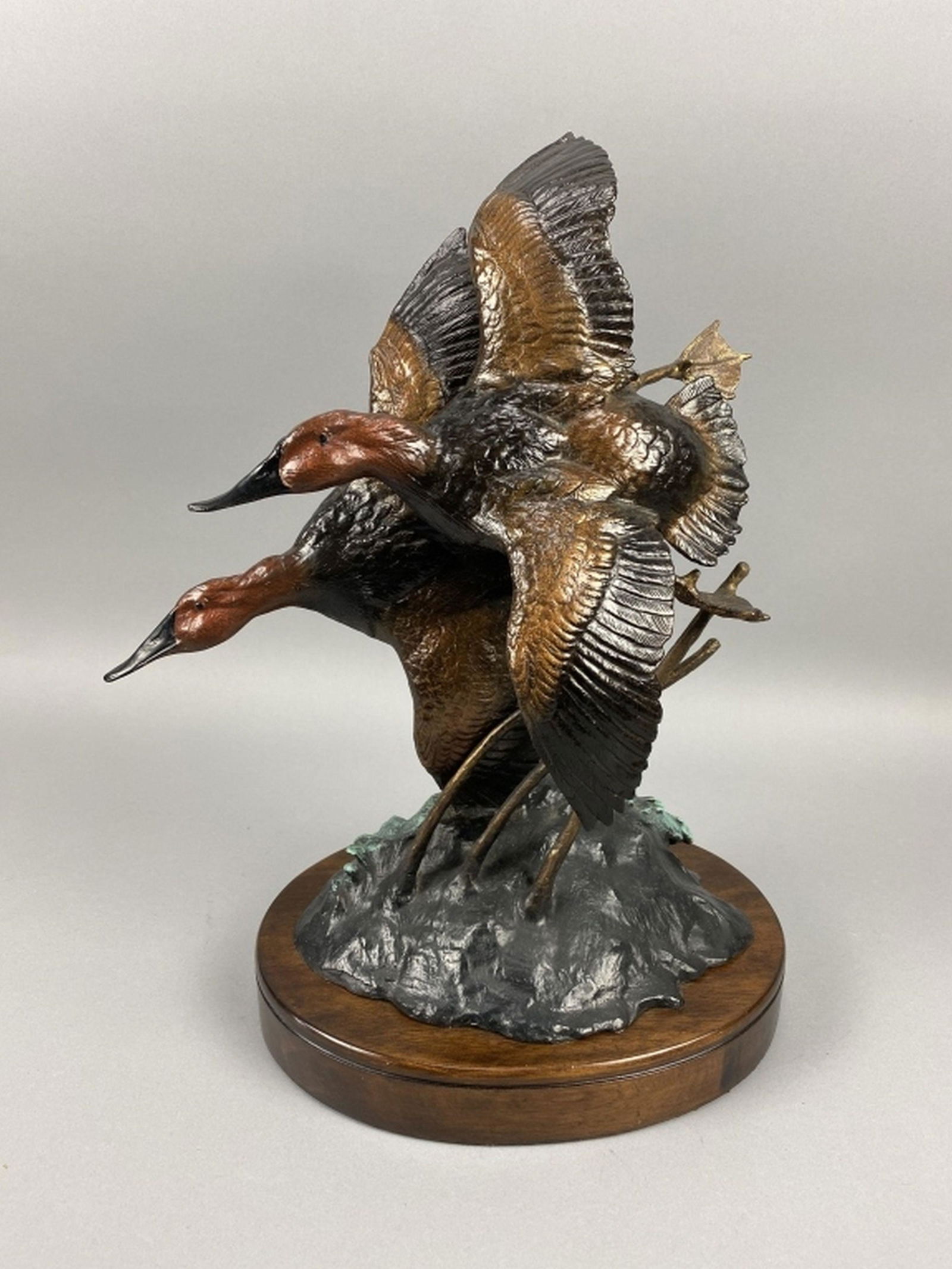 Cast Sculpture: "wave runners" by Ronnie Wells premium collection, features 2 canvasback drakes, good condition, mounted on wooden base, 19"T x 14"L, est. 100 - 200