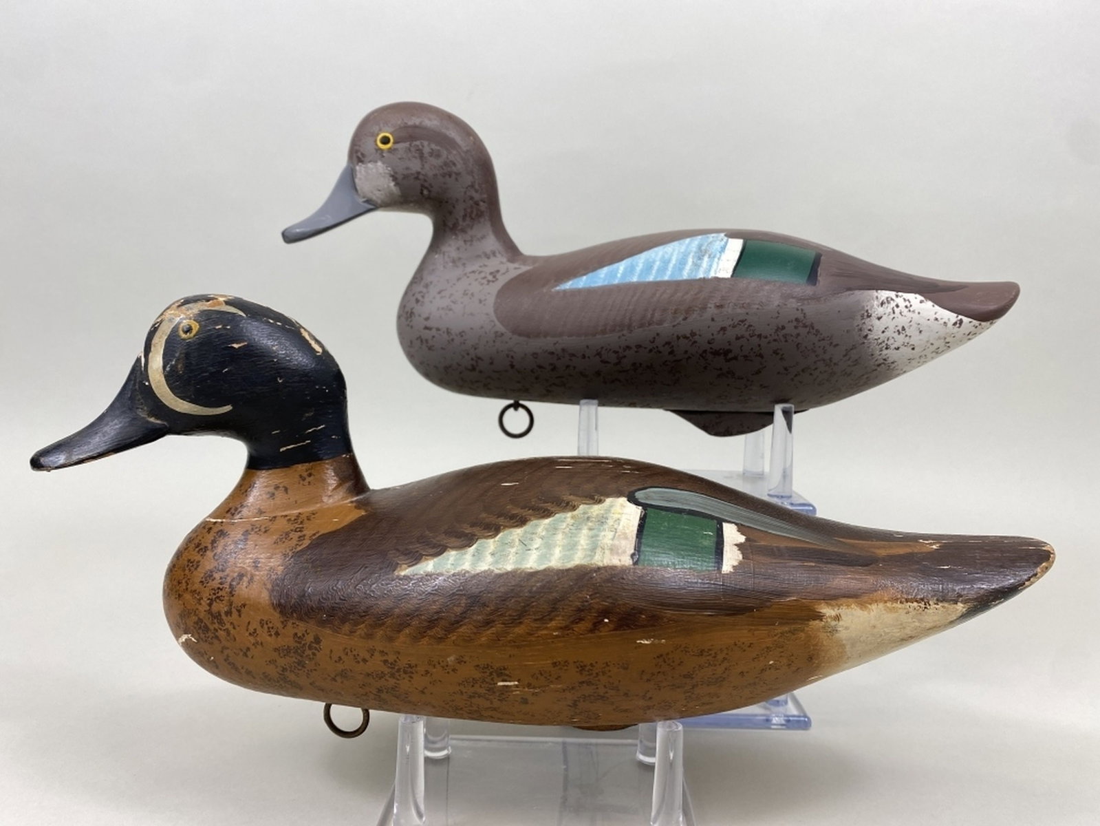 2 Madison Mitchell Blue-Winged Teal Duck Decoys: Havre de Grace, MD, 1 drake & 1 hen, painted eyes, solid bodies & original paint, drake is older with gunning wear & paint flaking, branded "CASTLE HAVEN" on bottom, hen has 1 shot mark on head otherw