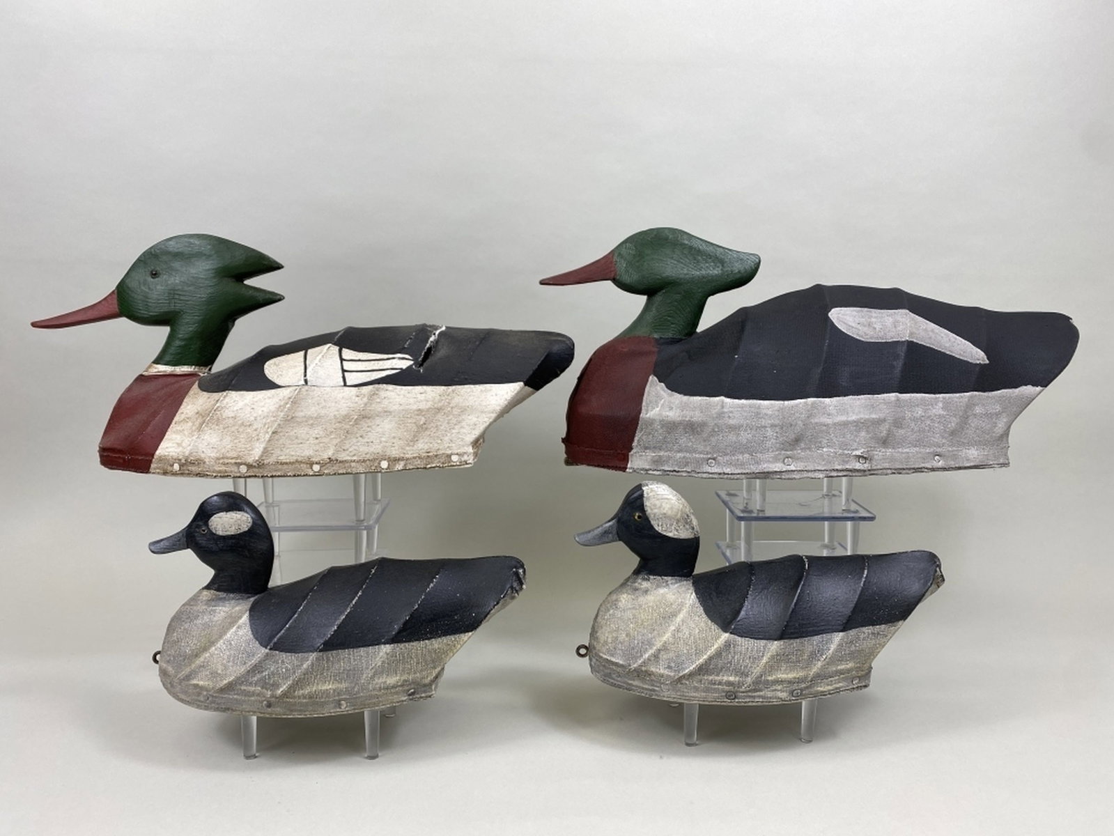 4 Decoys: 1 pr of buffleheads & 1 red-breasted merganser drake by William Mosely, Knotts Island, NC, glass eyes, canvas over wire hollow bodies with wooden heads & bottom boards, original paint, "WM" carved on