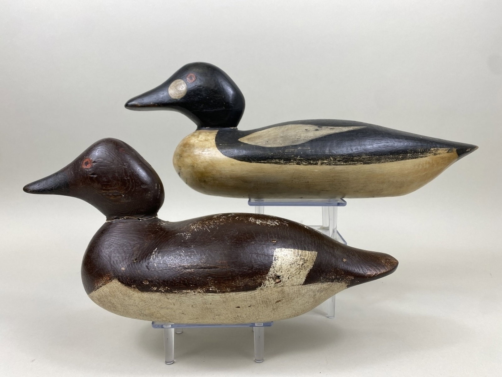 2 Mason Goldeneye Duck Decoys: Detroit, MI, standard grades, painted eyes, solid bodies, replaced neck filler, hen is combination of original & working paint, shot marks & gunning wear, drake is repainted with light wear, 14.5"L - 