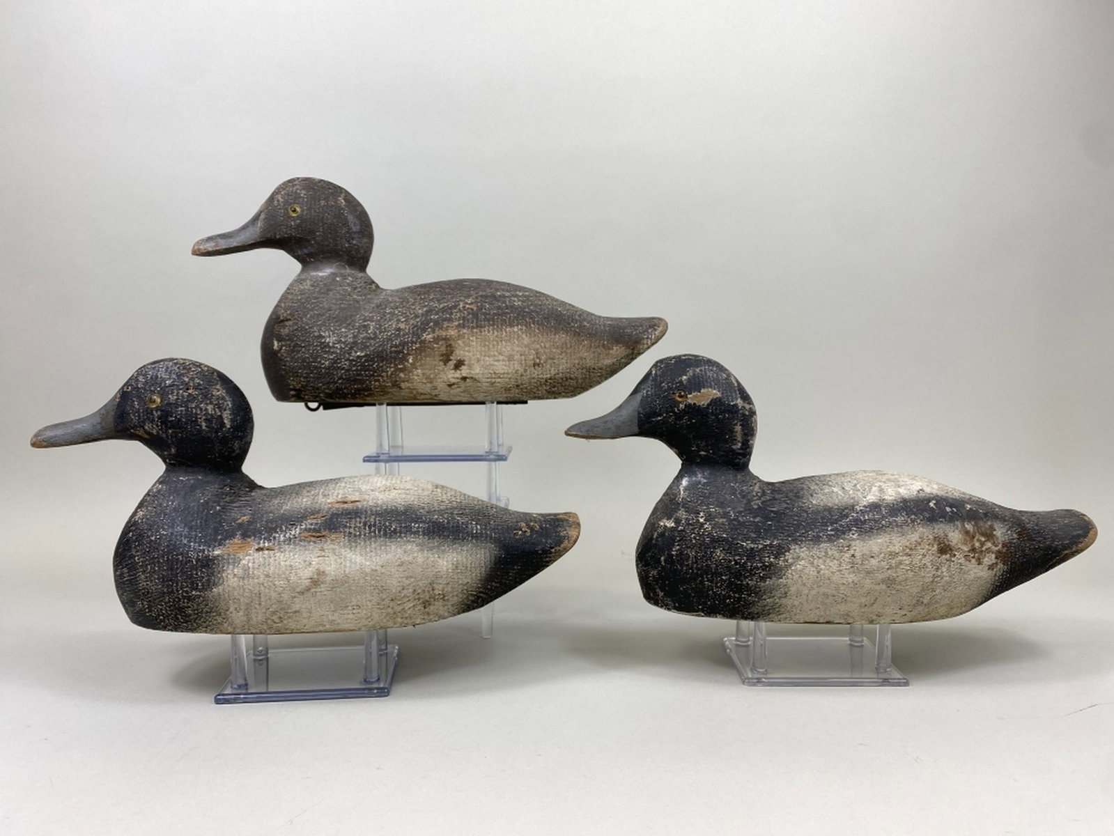 3 Factory Bluebill Duck Decoys: 2 drakes & 1 hen, glass eyes, solid bodies, original paint, light gunning wear, hen has bill chip, sizes range 14"L - 14.5"L, est. 150 - 250
