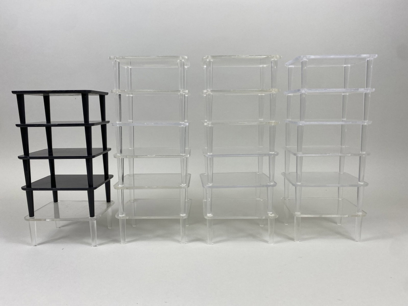 23 Plastic Decoy Display Stands: 19 clear & 4 black, all in fair condition, normal wear, light scratches & rubs, sizes range 4.25"L - 3.5"L x 2"T, est. 50 - 100