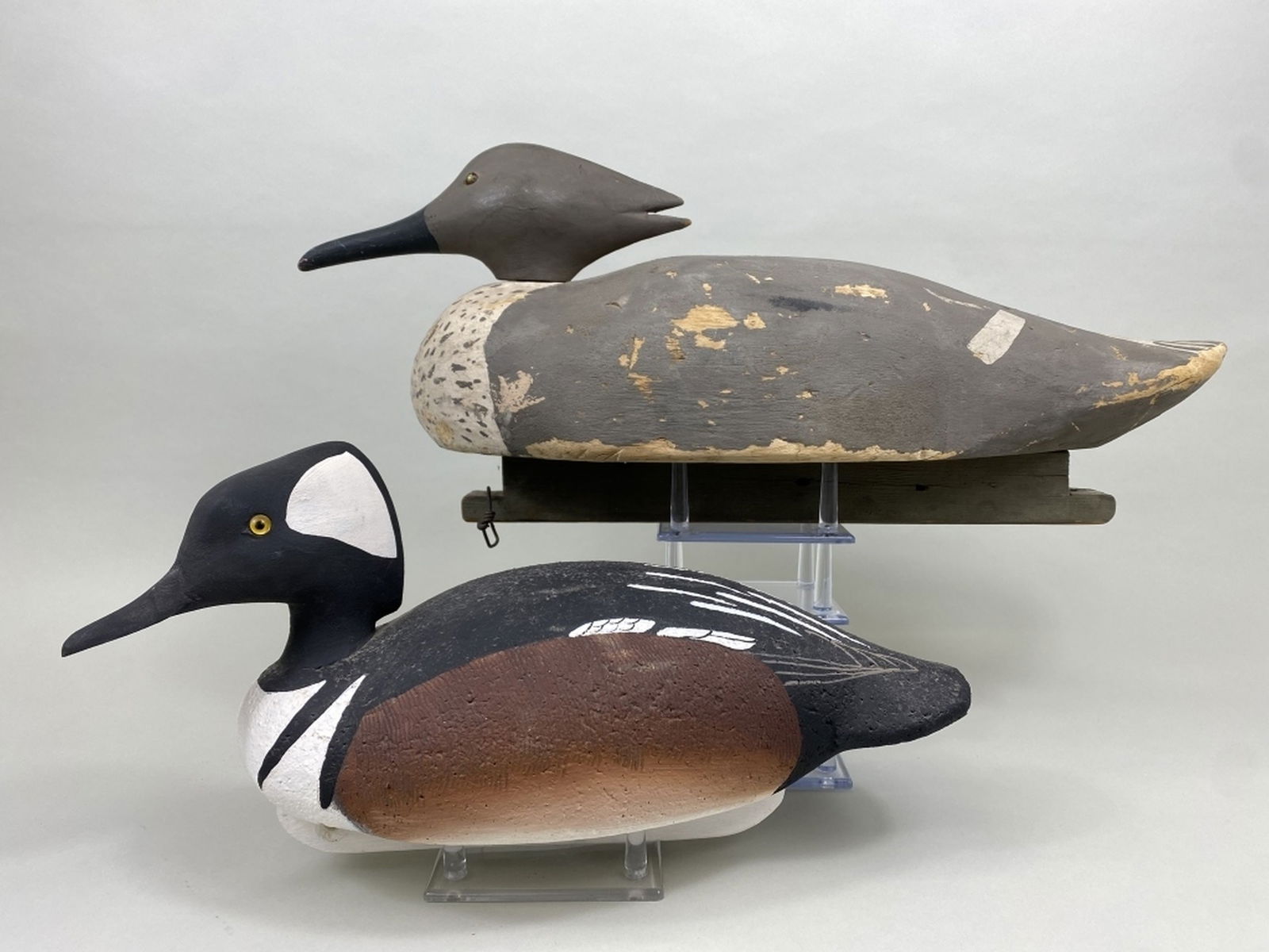 2 Duck Decoys: 1 hooded merganser drake by Ronald Laber, Fishing Creek, MC, glass eyes, cork body with wooden head & keel, excellent original paint, signed, branded & dated 1999 & 1 merganser hen by Ardel Waterfield